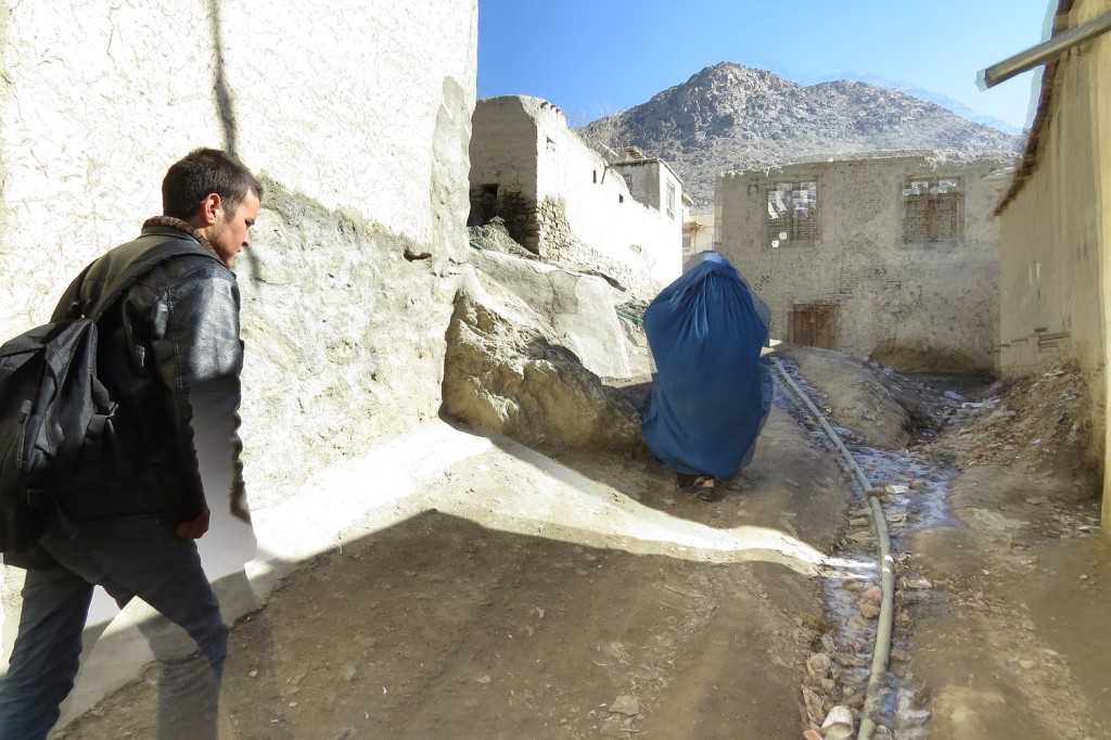 Going up the hill. The water pipe can be seen in a gulley. Zuhair’s mother walks in front of Zek. Photo by Dr. Hakim.