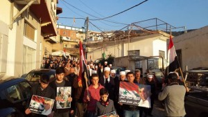 Procession in Ein Qiniyya following the Israeli airstrike in Jaramana: note the focus is primarily on commemorating Farhan Sha’alan rather than Quntar. Photo via Syria Comment.