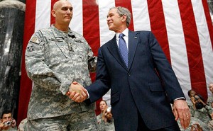 US President George W. Bush stands on stage with U.S. Army Gen. Ray Odierno, commander, Mulitnational Force Iraq, after Bush addressed U.S. military and diplomatic personnel at Al Faw Palace on Camp Victory in Baghdad, Dec. 14, 2008. White House photo by Eric Draper