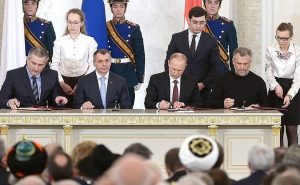 Agreement on the accession of the Republic of Crimea to the Russian Federation signed. The document bears the signatures of President of the Russian Federation Vladimir Putin, Chairman of the State Council of the Republic of Crimea Vladimir Konstantinov, Prime Minister of the Republic of Crimea Sergei Aksyonov and Chairman of the Coordinating Council for the establishment of the Sevastopol municipal administration Alexei Chaly. Photo Credit: Kremlin.ru