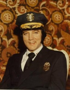Elvis Presley posing in his Denver police uniform