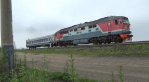 Russian Railways locomotive pulling a passenger rail car headed for North Korea. Photo by Leonid Kozlov. 