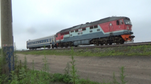 Russian Railways locomotive pulling a passenger rail car headed for North Korea. Photo by Leonid Kozlov.
