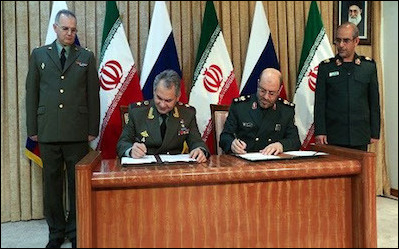 Russia's defense minister Sergei Shoigu (seated, left) and Iranian counterpart Hossein Dehghan sign an agreement to expand military ties, Tehran, January 2015. Not since World War II, has Tehran permitted a foreign country to base itself in Iran, but in August 2016, it allowed Moscow to use its Hamedan base.