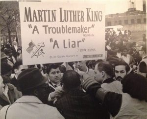 MLK in center back to camera, Morganstern is behind the poster, partially hidden