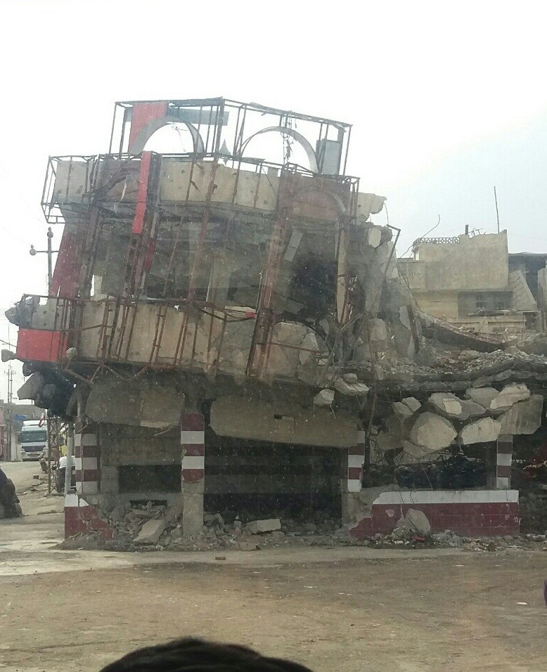 Building in Mosul decimated by bombing, March 2018. Photo: Abu Mohammed Shop remains open in area of Mosul decimated by bombing, March, 2018. Photo: Abu Mohammed.