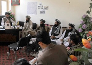 The Terezayi District governor (seated at desk) speaks with Mullah Shah Mohammed, Khost Ulema Council director, during a three-district visit promoting peace and government unity April 7. (Photo by U.S. Air Force Master Sgt. Matthew Lohr, Khost Provincial Reconstruction Team Public Affairs)