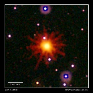 Images from Swift's Ultraviolet/Optical (white, purple) and X-Ray telescopes (yellow and red) were combined to make this view of Swift J1644+57. Evidence of the flares is seen only in the X-ray image, which is a 3.4-hour exposure taken on March 28, 2011. Credit: NASA/Swift/Stefan Immler