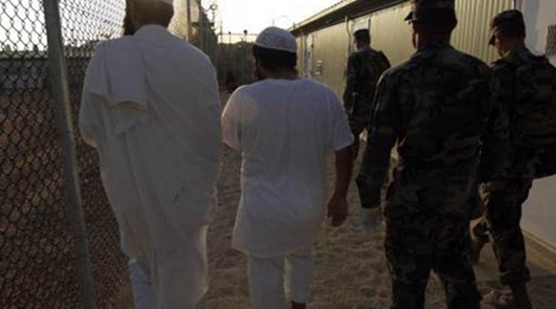 Guantanamo detainees being shown to their new living quarters. Photo by Chief Petty Officer John F. Williams, U.S. Navy.