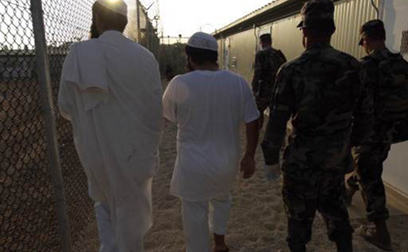 Guantanamo detainees being shown to their new living quarters. Photo by Chief Petty Officer John F. Williams, U.S. Navy.