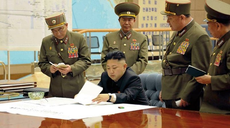 KimKim Jong-un sitting at desk in what appears a dedicated military operations room (Korean Central News Agency via NDU Press)