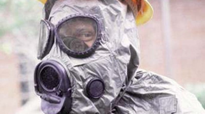 United States Airman wearing an M-17 nuclear, biological, and chemical warfare mask and hood. Photo by Senior Airman Walker, Kadena Air Force Base. - U.S. Department of Defense (DOD)