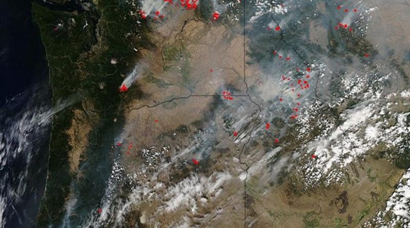 This natural-color satellite image was collected by the Moderate Resolution Imaging Spectroradiometer (MODIS) aboard the Aqua satellite on Aug. 25, 2015. Actively burning areas, detected by MODIS's thermal bands, are outlined in red. Credit NASA image courtesy Jeff Schmaltz, MODIS Rapid Response Team. Caption: NASA/Goddard, Lynn Jenner