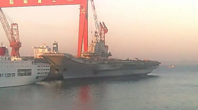 China's aircraft carrier the Liaoning (formerly the Russian ship Riga and subsequently renamed the Varyag before being sold to China) being refit in 2011. Photo Credit: Yhz1221, Wikipedia Commons.