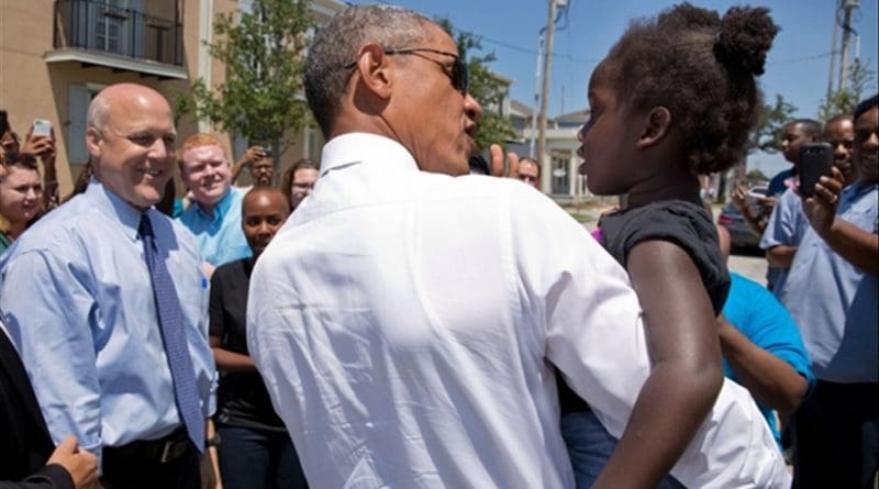 President Barack Obama greets a youngster during a walk through the Tremé neighborhood of New Orelans, La., with Mayor Mitch Landrieu, left, Aug. 27, 2015. The area experienced significant flooding during Hurricane Katrina ten years ago. (Official White House Photo by Pete Souza)