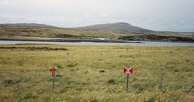Although some minefields have been cleared, a substantial number of them still exist in the islands, such as this one at Port William on East Falkland. Photo by Apcbg, Wikipedia Commons.