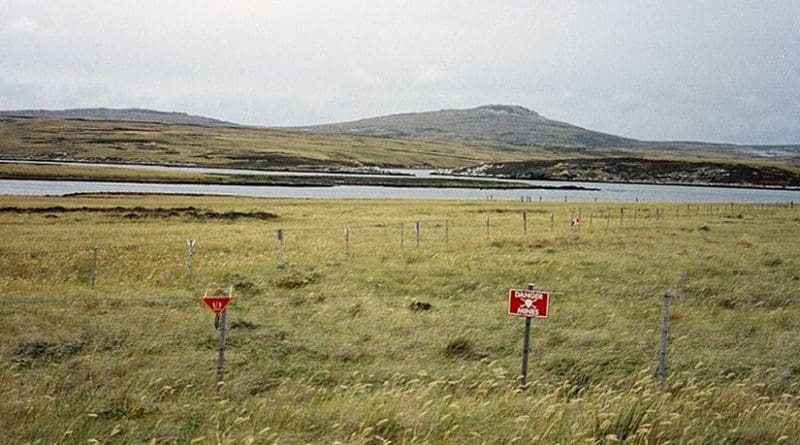 Although some minefields have been cleared, a substantial number of them still exist in the islands, such as this one at Port William on East Falkland. Photo by Apcbg, Wikipedia Commons.