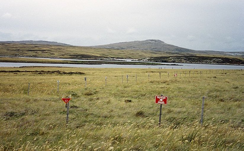 Although some minefields have been cleared, a substantial number of them still exist in the islands, such as this one at Port William on East Falkland. Photo by Apcbg, Wikipedia Commons.