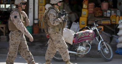 Two members of a US Marine Corps Female Engagement Team patrolling a town in Afghanistan. Photo Credit. US Marines, WIkipedia Commons.