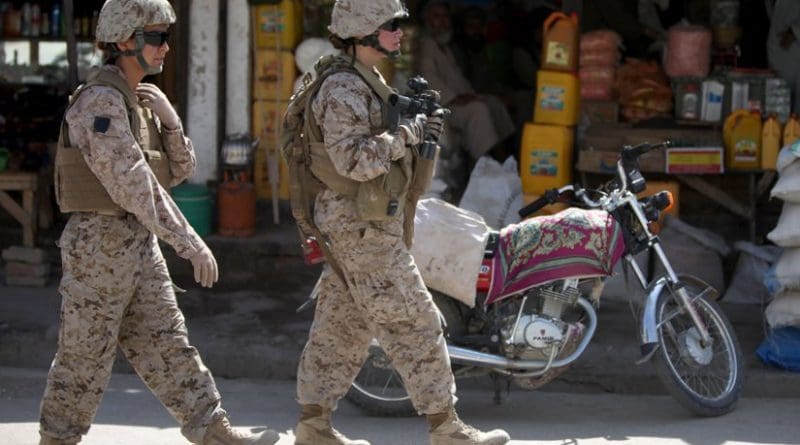 Two members of a US Marine Corps Female Engagement Team patrolling a town in Afghanistan. Photo Credit. US Marines, WIkipedia Commons.