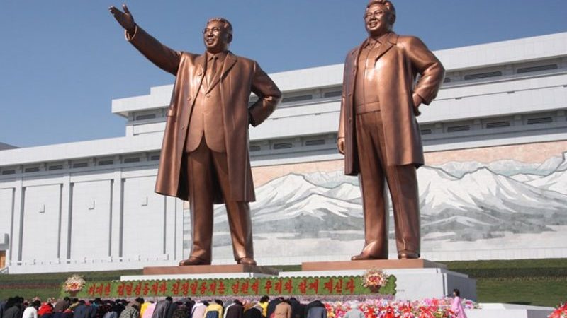 North Koreans bowing to the statues of Kim Il-sung (left) and Kim Jong-il. Photo by J.A. de Roo, Wikipedia Commons.