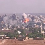 Coalition airstrike on Islamic State position, October 2014. Photo Credit: Voice of America News: Scott Bobb reports from the Suruç, Turkey/ Kobane, Syrian border; "Turkish Border Towns Hosting Thousands of Kobani Refugees", Wikipedia Commons.