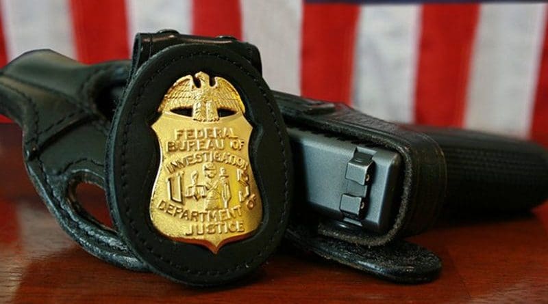 FBI badge and gun. Source: Wikipedia Commons.