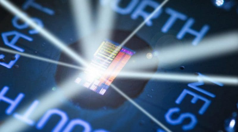 This packaged electronic-photonic processor microchip under illumination reveals the chip's primary features. The light rays emanating from the chip are drawn to show that the processor talks to the outside world using light. Credit Image by Glenn J. Asakawa, University of Colorado, Glenn.Asakawa@colorado.edu