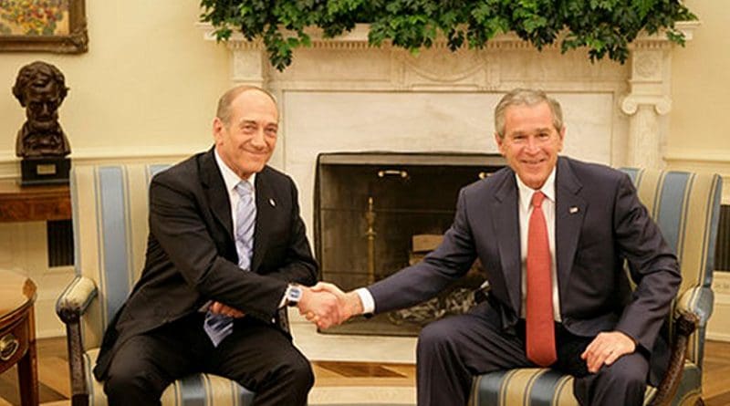 President George W. Bush exchanges handshakes with Prime Minister Ehud Olmert of Israel during their meeting Tuesday, May 23, 2006, in the Oval Office. Photo by Eric Draper, White House, Wikipedia Commons.