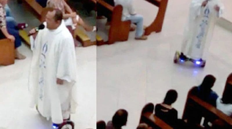 A screen grab from a video shows Father Albert San Jose on a hoverboard while singing to his congregation before the final blessing of the Christmas Eve Mass.
