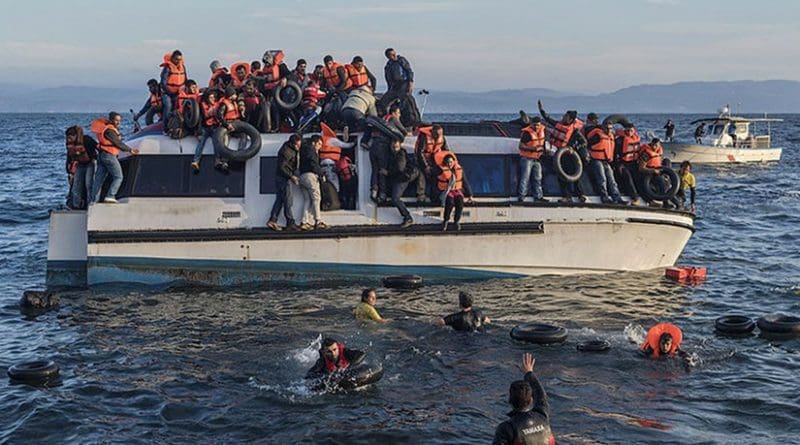 Syrian and Iraqi immigrants getting off a boat from Turkey on the island of Lesbos, Greece. Photo by Ggia, Wikipedia Commons.