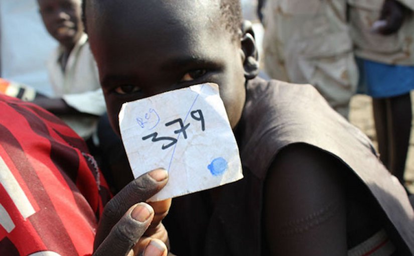 In March 2015, a boy holds his registration number following a ceremony formalizing his release from the South Sudan Democratic Army (SSDA) Cobra Faction, in Lekuangole village, in Jonglei State. UNICEF/UNI181538/McKeever