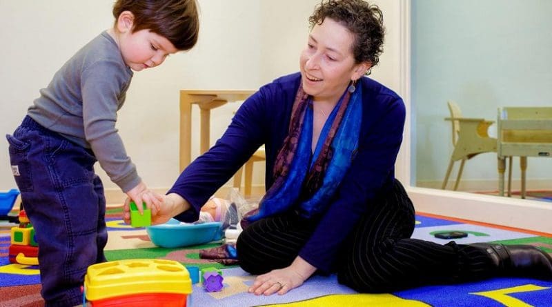 Diana Robins, PhD, of the A.J. Drexel Autism Institute, plays with a toddler who is in the age range that she believes all children should be screened for autism spectrum disorder. Credit Photo by Jeff Fusco.