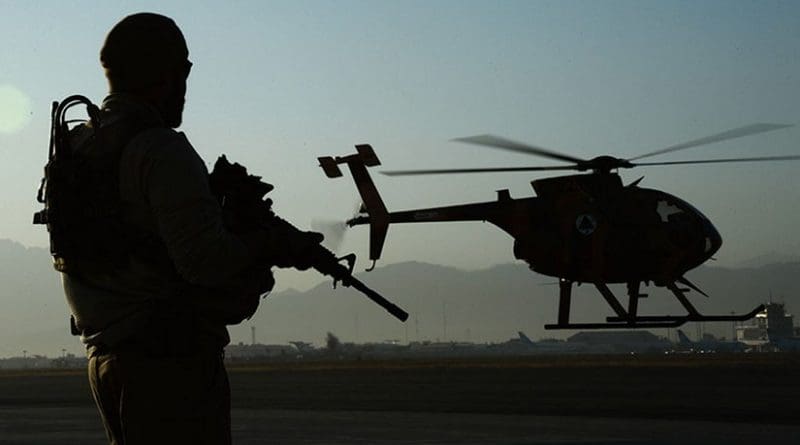 U.S. Army Train, Advise, Assist Command–Air personal security detail shift lead provides security while MD-530 Cayuse Warrior takes off with all-Afghan crew for combat mission, September 27, 2015 (U.S. Air Force/Sandra Welch)