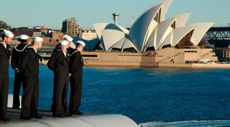 U.S. sailors man the rails aboard USS Kitty Hawk (CV-63) sails the Sydney Opera House while pulling into Sydney, Australia in 2005. US Navy Photo
