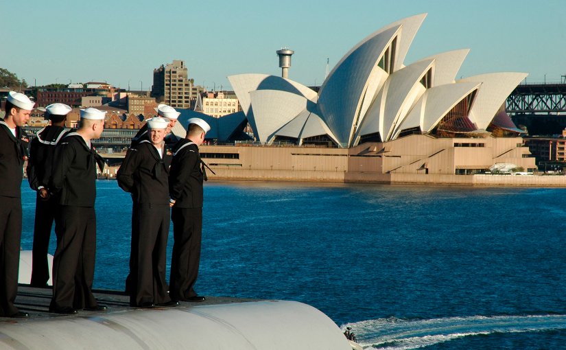 U.S. sailors man the rails aboard USS Kitty Hawk (CV-63) sails the Sydney Opera House while pulling into Sydney, Australia in 2005. US Navy Photo