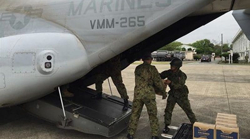 Japan Self-Defense Forces service members load earthquake relief items onto an MV-22B Osprey belonging to Marine Medium Tilt rotor Squadron 265, 31st Marine Expeditionary Unit at Marine Corps Air Station, Iwakuni, Japan, April 18, 2016. American 31st Marine Expeditionary Unit members were in Iwakuni to support relief efforts in response to the earthquakes that struck the island of Kyushu. Marine Corps photo by Capt. Jennifer Giles