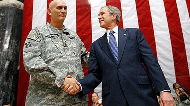 US President George W. Bush stands on stage with U.S. Army Gen. Ray Odierno, commander, Mulitnational Force Iraq, after Bush addressed U.S. military and diplomatic personnel at Al Faw Palace on Camp Victory in Baghdad, Dec. 14, 2008. White House photo by Eric Draper