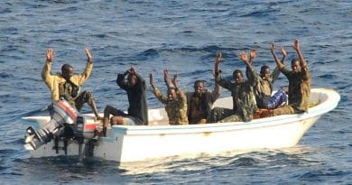 Suspected pirates wait for members of the counter-piracy operation to board their boat. Photo: US Navy/Jason R Zalasky