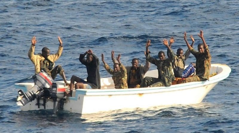 Suspected pirates wait for members of the counter-piracy operation to board their boat. Photo: US Navy/Jason R Zalasky