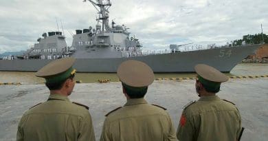 Vietnamese military officials watch as USS Curtis Wilbur (DDG 54) prepares to moor in the Vietnamese port of Da Nang. U.S. Navy photo by Photographer’s Mate 2nd Timothy Smith