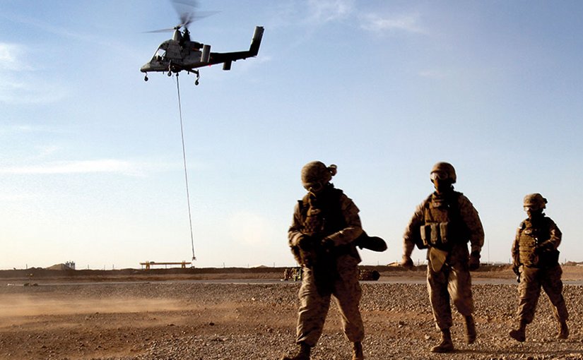 Marines with Combat Logistics Battalion 5 return after learning about downward thrust of Kaman K1200 (“K-MAX”) unmanned helicopter during initial testing in Helmand Province, Afghanistan (U.S. Marine Corps/Lisa Tourtelot)