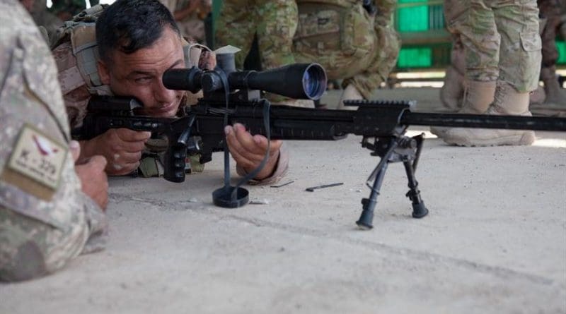 A New Zealand soldier, left, advises an Iraqi soldier adjusting his rifle’s sights at Camp Taji, Iraq, June 7, 2016. Increased training for Iraqi police officers will add to the existing 23,000 trained Iraqi forces, and training will soon expand to the Iraq border security force, British army Maj. Gen. Doug Chalmers, Combined Joint Task Force-Operation Inherent Resolve deputy commander for strategy and sustainment, told the Pentagon press corps, today. Army photo by Spc. Jessica Hurst