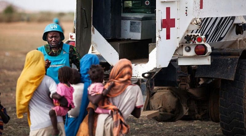 A UNAMID peacekeeper from Tanzania interacts with children in Karbab village, South Darfur, during a routine patrol. Credit: UN Photo/Albert González Farran