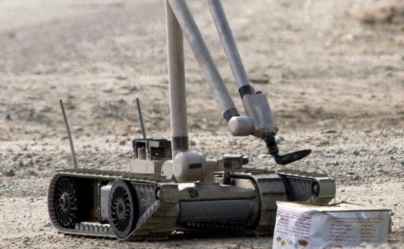 A U.S. Army explosive ordnance disposal (EOD) robot, “i-Robot”, pulls the wire of an alleged improvised explosive device (IED), found by the Iraqi Police. U.S. Navy photo by Journalist 1st Class Jeremy L. Wood, Wikipedia Commons.