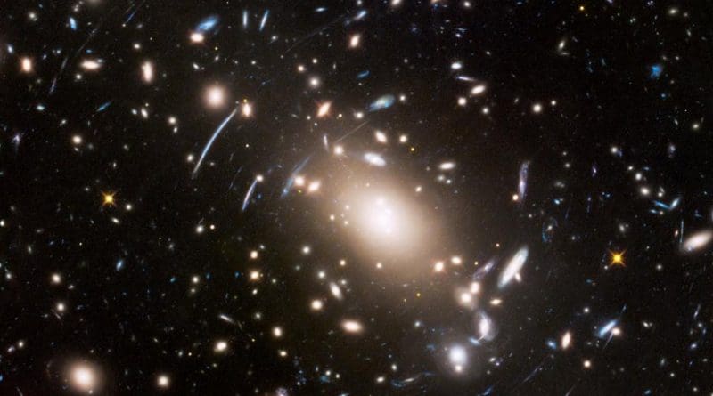 This view of a massive cluster of galaxies unveils a very cluttered-looking universe filled with galaxies near and far. Some are distorted like a funhouse mirror through a "space warp" phenomenon first predicted by Einstein a century ago. Credit NASA, ESA, and J. Lotz (STScI)