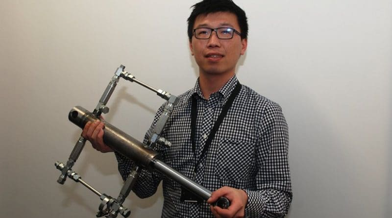 Ruichen Wang with the prototype shock absorber.