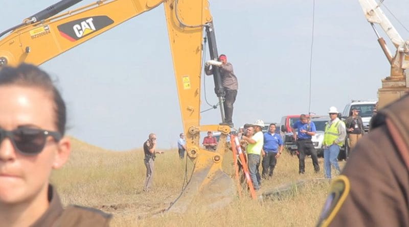Lakota man locks himself to construction equipment to stop the construction of the Dakota Access Pipeline near the Standing Rock Indian Reservation in North Dakota. Photo by Desiree Kane, Wikipedia Commons.