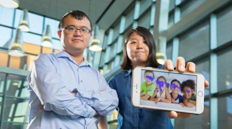 From left to right, Wenyao Xu, University at Buffalo assistant professor of computer science and engineering, and undergraduate Kun Woo Cho, show a smartphone with the autism tracking software they are developing. The purple blotches show where a child looks. This photo indicates no autism spectrum disorder. Credit Credit: Douglas Levere.