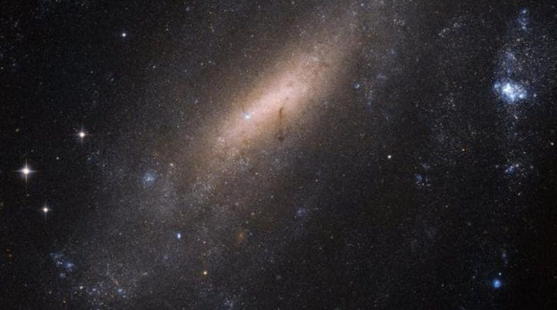 IC 5201 sits over 40 million light-years away from us. As with two thirds of all the spirals we see in the universe -- including the Milky Way, the galaxy has a bar of stars slicing through its center. Credit Credit: ESA/Hubble & NASA